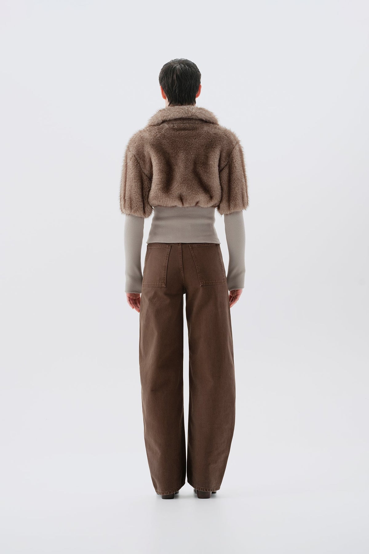 Cropped beige and gray faux fur jacket with statement collar and ribbed knit trim at waist and cuffs, back view