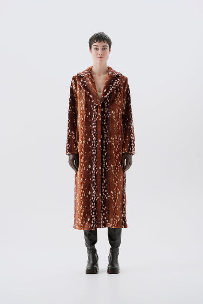 Model pictured from the back wearing a long brown faux fur coat with a bambi pattern