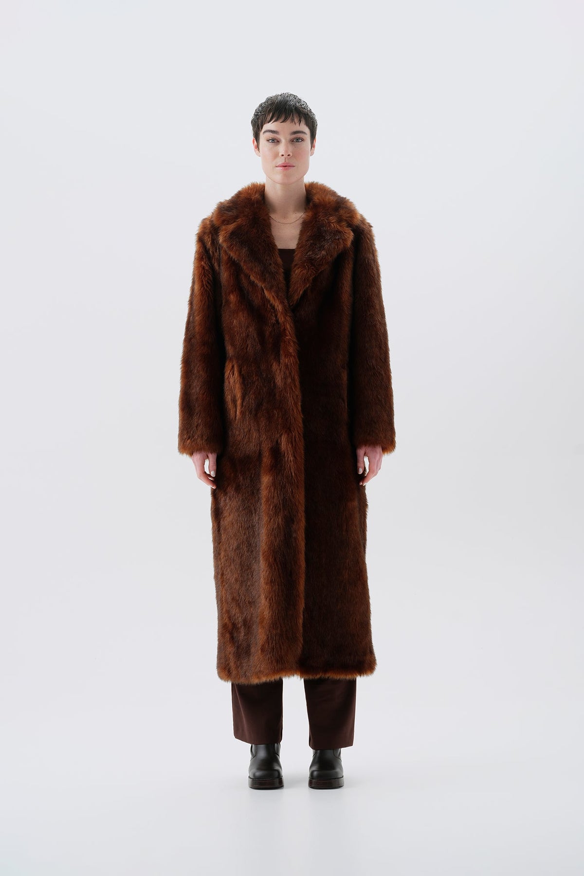 Model wearing a warm and long brown faux fur coat