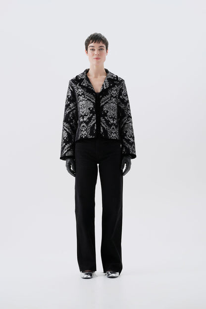 Black and silver patterned jacket, front view, paired with black pants