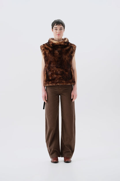 Model wearing a brown faux fur vest and pants on a white background