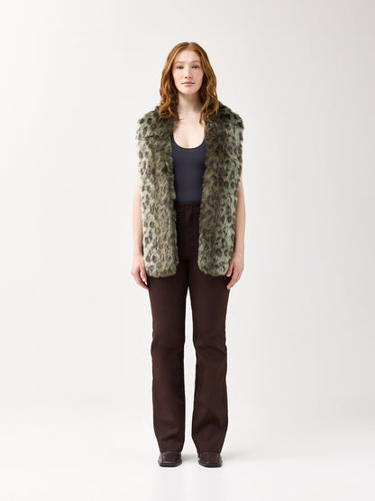 Woman wearing a green leopard faux fur scarf on a white background