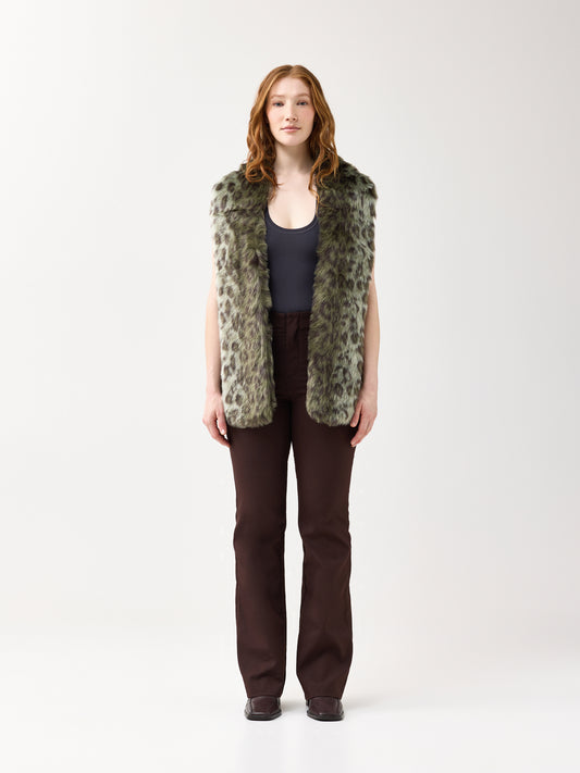 Woman wearing a green leopard faux fur scarf on a white background